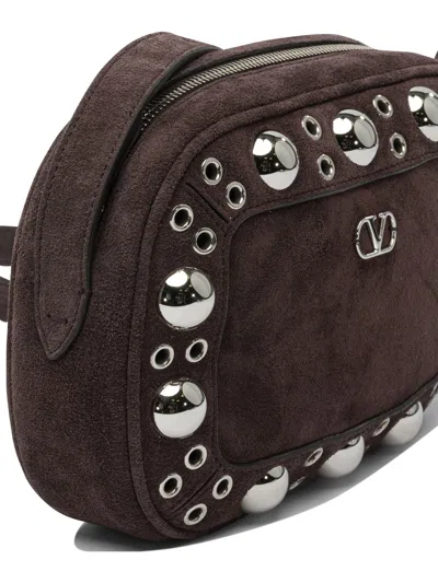 Valentino Garavani Dome-shaped Crossbody Bag With Metallic Eyelets And Adjustable Strap In Brown