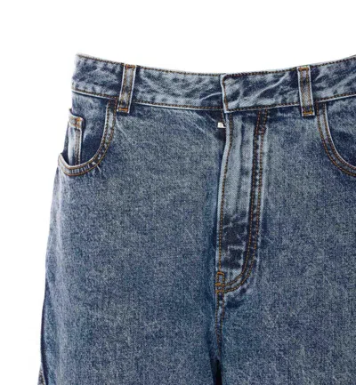Alaïa Twisted Stonewashed Denim Jeans In Blue