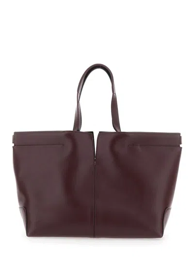 Tod's Bordeaux Tote Bag With Two Top Handles And Embossed Logo Lettering On The Front In Burgundy