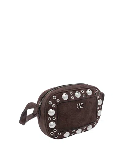 Valentino Garavani Dome-shaped Crossbody Bag With Metallic Eyelets And Adjustable Strap In Brown