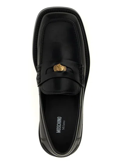 Moschino Strap Penny Round Toe Loafers In Black