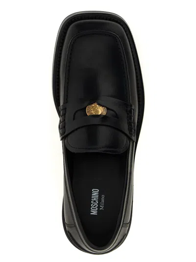 Moschino Strap Penny Round Toe Loafers In Black