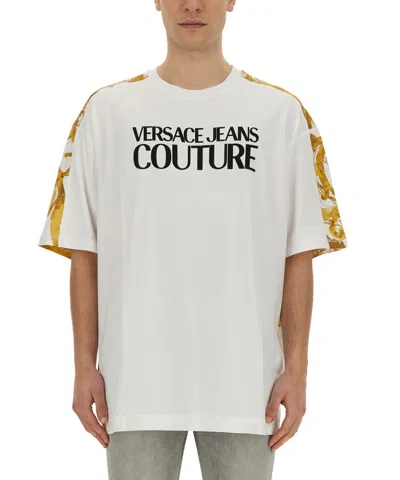 Versace Jeans Couture Oversized T-shirt With Bold Logo And Intricate Patterned Sleeves In White