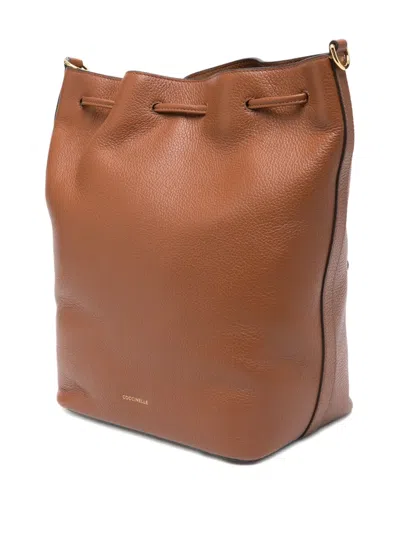 Coccinelle Medium Beat Generation Drawstring Bucket Bag In Brown