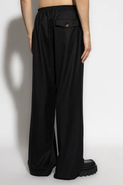 Moschino Elasticated-waist Gold-button Trousers In Black