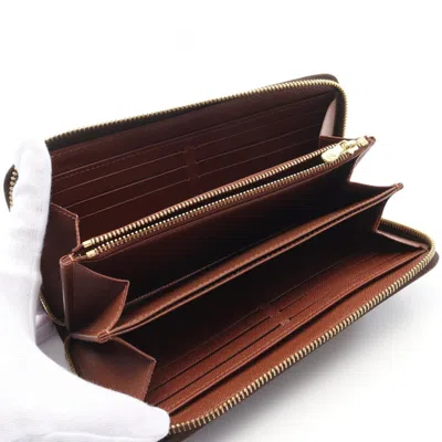 Pre-owned Louis Vuitton Brown Coated Canvas Monogram Pvc Long Wallet (bi-fold) ()