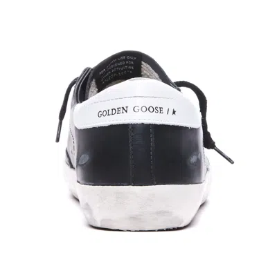 Golden Goose 'super-star' Black Low Top Sneakers With Logo Patch And Suede Details In Leather Man In Black
