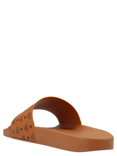 Mcm Male Monogram Print Rubber Slides In Brown