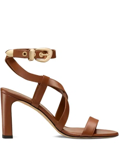 Stuart Weitzman Buckle-embellished Crossover Sandals In Brown