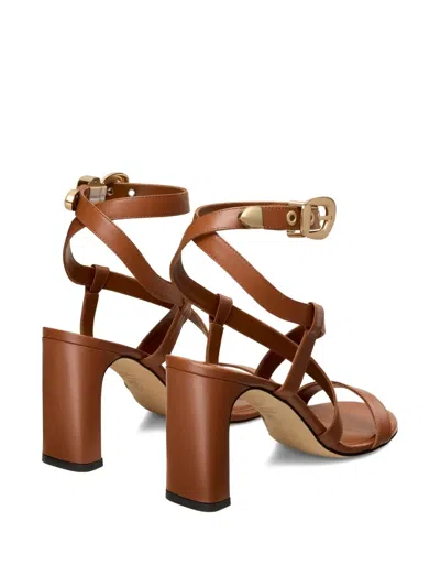 Stuart Weitzman Buckle-embellished Crossover Sandals In Brown