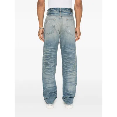 Amiri Men Blue Jeans With Ripped Details On The Front And Logo Patch On The Rear In Denim Man In Blue