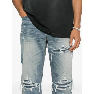 Amiri Men Blue Jeans With Ripped Details On The Front And Logo Patch On The Rear In Denim Man In Blue