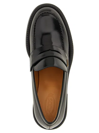 Tod's Black Loafers With Penny Slot And Logo Lettering On The Side In Black