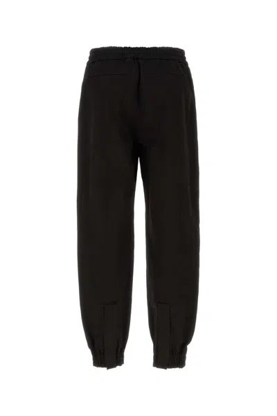 Alexander Mcqueen Men Printed Trousers In Black