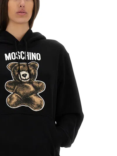 Moschino Graphic Print Hooded Kangaroo Pocket Knitwear In Black