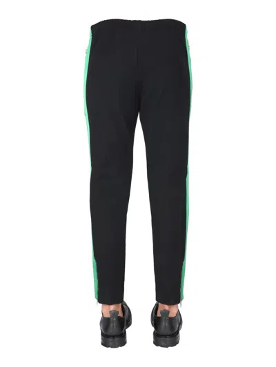 Alexander Mcqueen Jogging Pants With Embroidered Skull In Black
