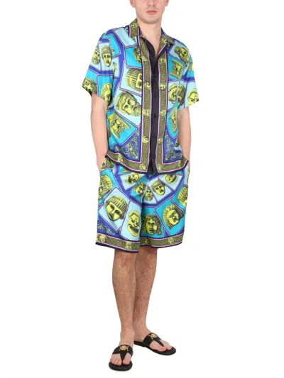 Versace Le Maschere Print Silk Shorts In Blue