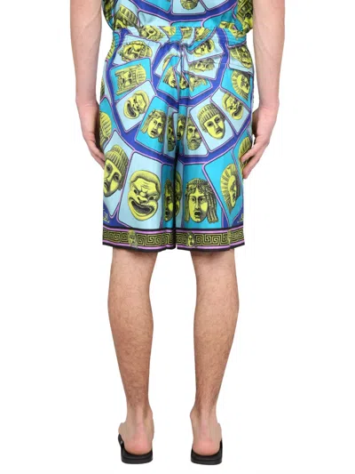 Versace Le Maschere Print Silk Shorts In Blue