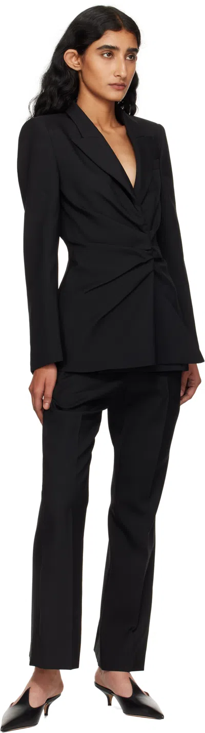 Alexander Mcqueen Tailored Wool Trousers Featuring Flared Hem In Black