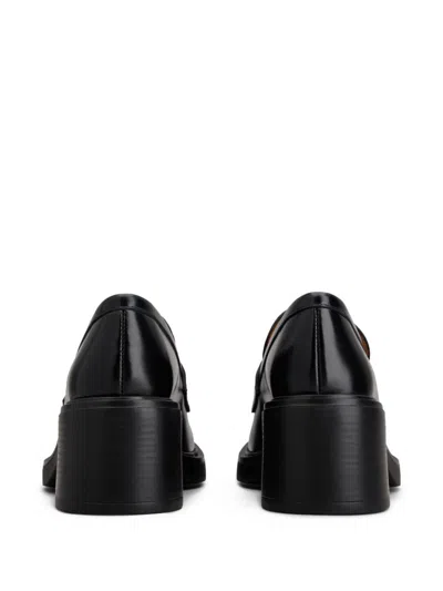 Tod's Black Loafers With Penny Slot And Logo Lettering On The Side In Black