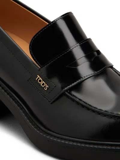 Tod's Black Loafers With Penny Slot And Logo Lettering On The Side In Black