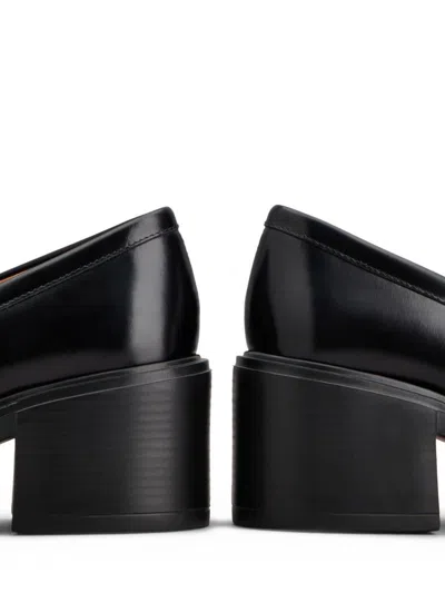 Tod's Black Loafers With Penny Slot And Logo Lettering On The Side In Black