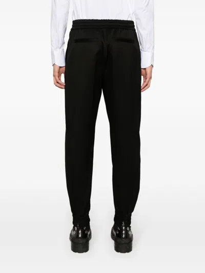 Alexander Mcqueen Men Printed Trousers In Black