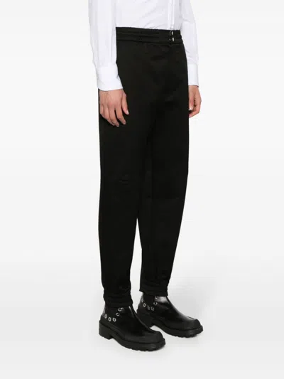 Alexander Mcqueen Men Printed Trousers In Black