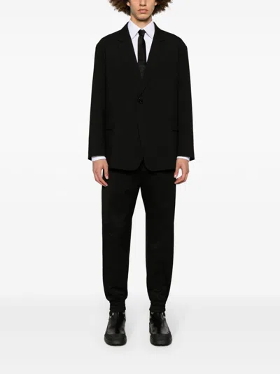 Alexander Mcqueen Men Printed Trousers In Black
