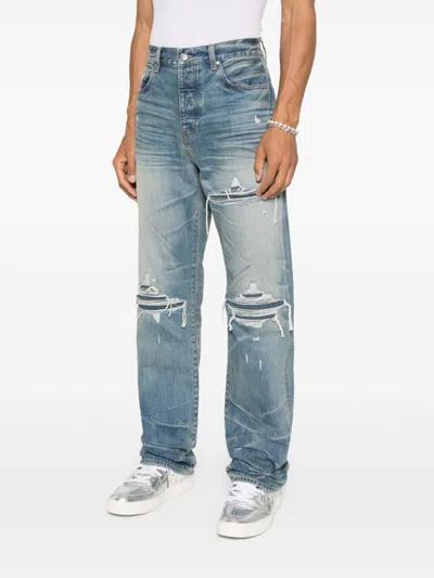 Amiri Men Blue Jeans With Ripped Details On The Front And Logo Patch On The Rear In Denim Man In Blue
