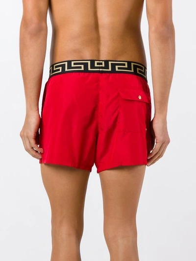 Shop Versace 'greek Key Medusa' Swim Shorts In Red