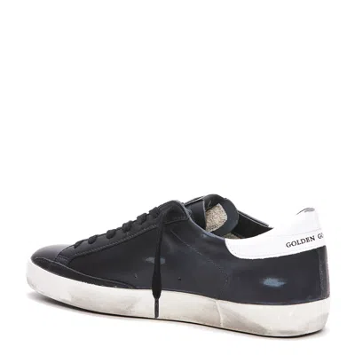 Golden Goose 'super-star' Black Low Top Sneakers With Logo Patch And Suede Details In Leather Man In Black