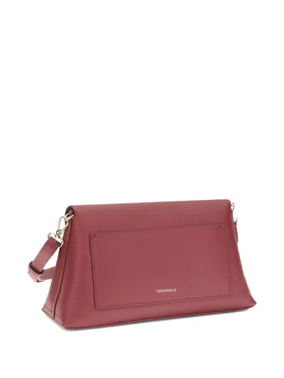 Coccinelle Medium Nikla Circular-clasp Calf-leather Shoulder Bag In Red