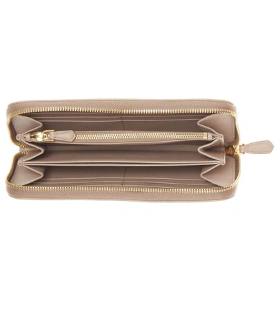 Shop Prada Saffiano Leather Zip-around Wallet In Cammeo