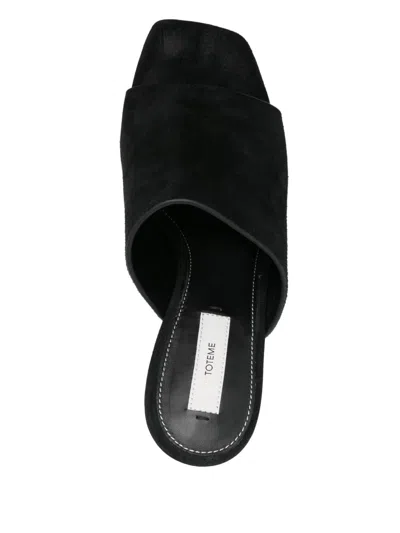 Totême Sculpted Heel Suede Mules With Toe Strap In Black