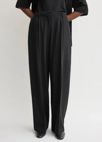 Totême Pleated Wool Wide-leg Trousers In Black
