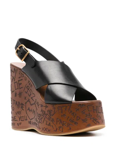 Chloé Women 'maxime' Black Wedges With High Embossed High Wedge Heel And Crossover Strap On The Toe In Black