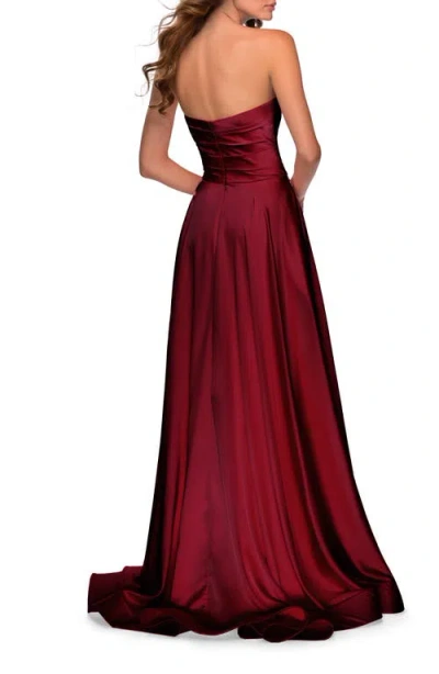 La Femme Strapless Satin Gown With Pleated Bodice And Slit In Burgundy