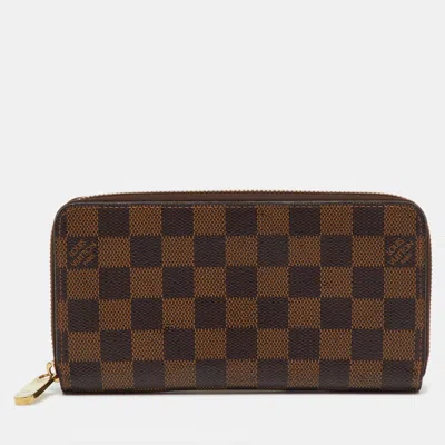 Pre-owned Louis Vuitton Damier Ebene Canvas Zippy Wallet In Brown