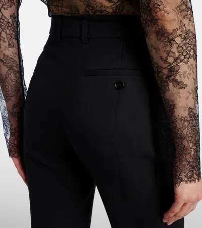 Alexander Mcqueen Tailored Wool Trousers Featuring Flared Hem In Black