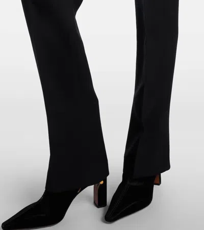 Alexander Mcqueen Tailored Wool Trousers Featuring Flared Hem In Black