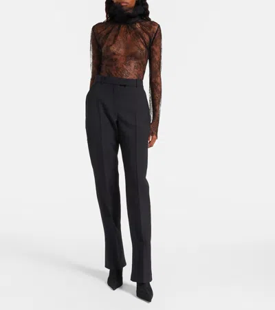 Alexander Mcqueen Tailored Wool Trousers Featuring Flared Hem In Black