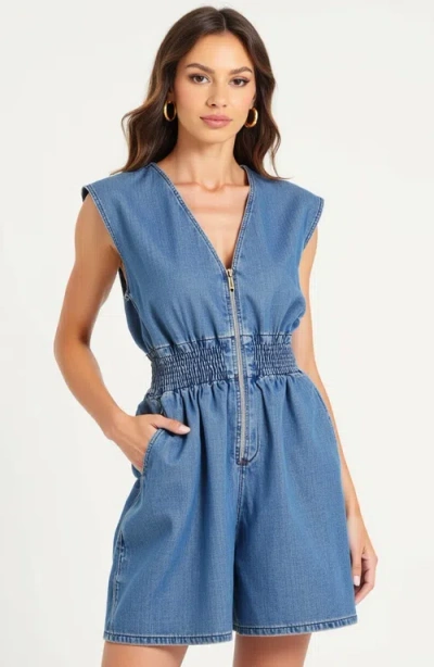 Modenaire Denim Romper With Cap Sleeves Smocked Waist And Front Zip Closure In Blue