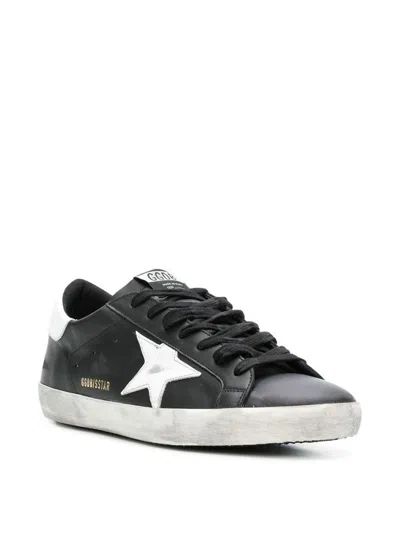 Golden Goose 'super-star' Black Low Top Sneakers With Logo Patch And Suede Details In Leather Man In Black