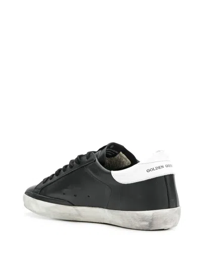 Golden Goose 'super-star' Black Low Top Sneakers With Logo Patch And Suede Details In Leather Man In Black