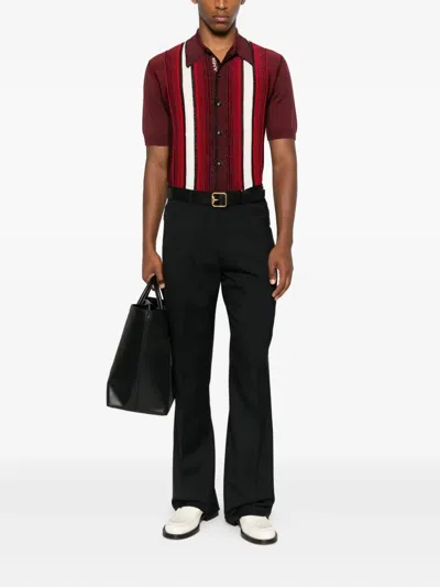 Amiri Button-fly Bootcut Trousers In Black