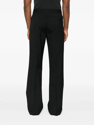 Amiri Button-fly Bootcut Trousers In Black
