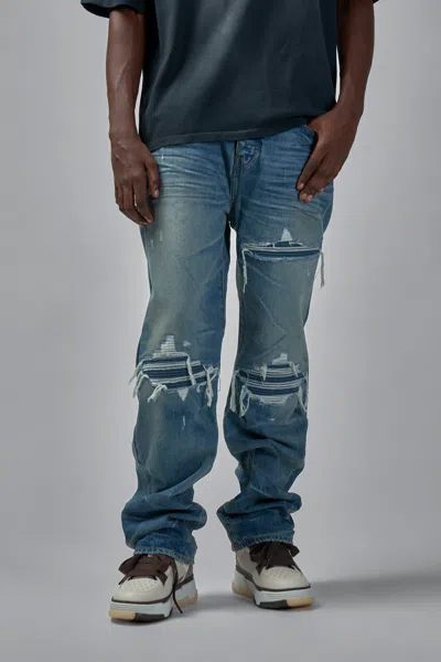 Amiri Men Blue Jeans With Ripped Details On The Front And Logo Patch On The Rear In Denim Man In Blue