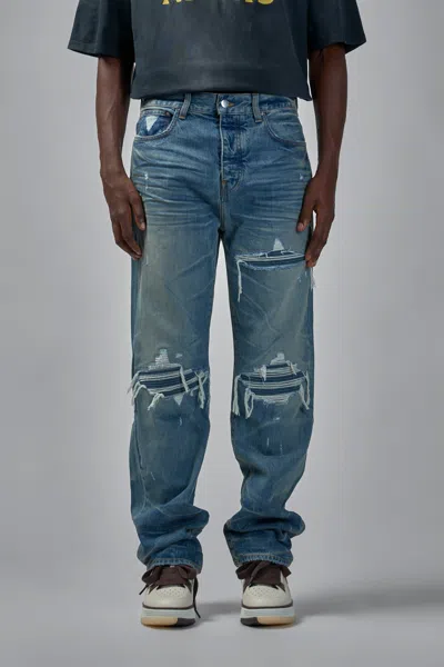 Amiri Men Blue Jeans With Ripped Details On The Front And Logo Patch On The Rear In Denim Man In Blue