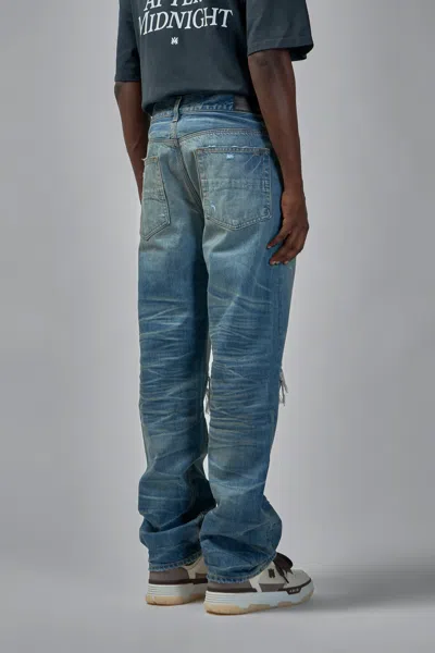 Amiri Men Blue Jeans With Ripped Details On The Front And Logo Patch On The Rear In Denim Man In Blue